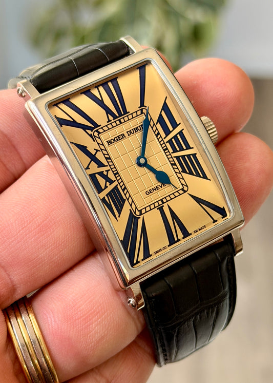 Roger Dubuis watch held in a hand with a blurred background